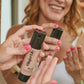 Woman using BioGlow Tinted Hydrator tallow makeup