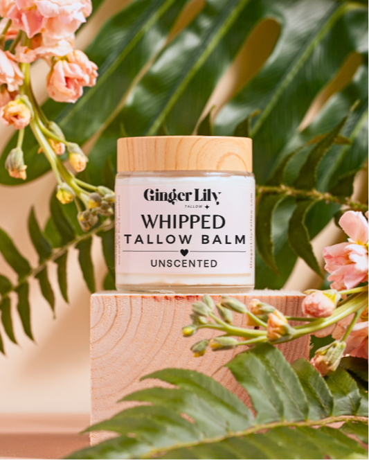 Ginger Lily whipped tallow balm unscented jar with flowers and leaves in the background